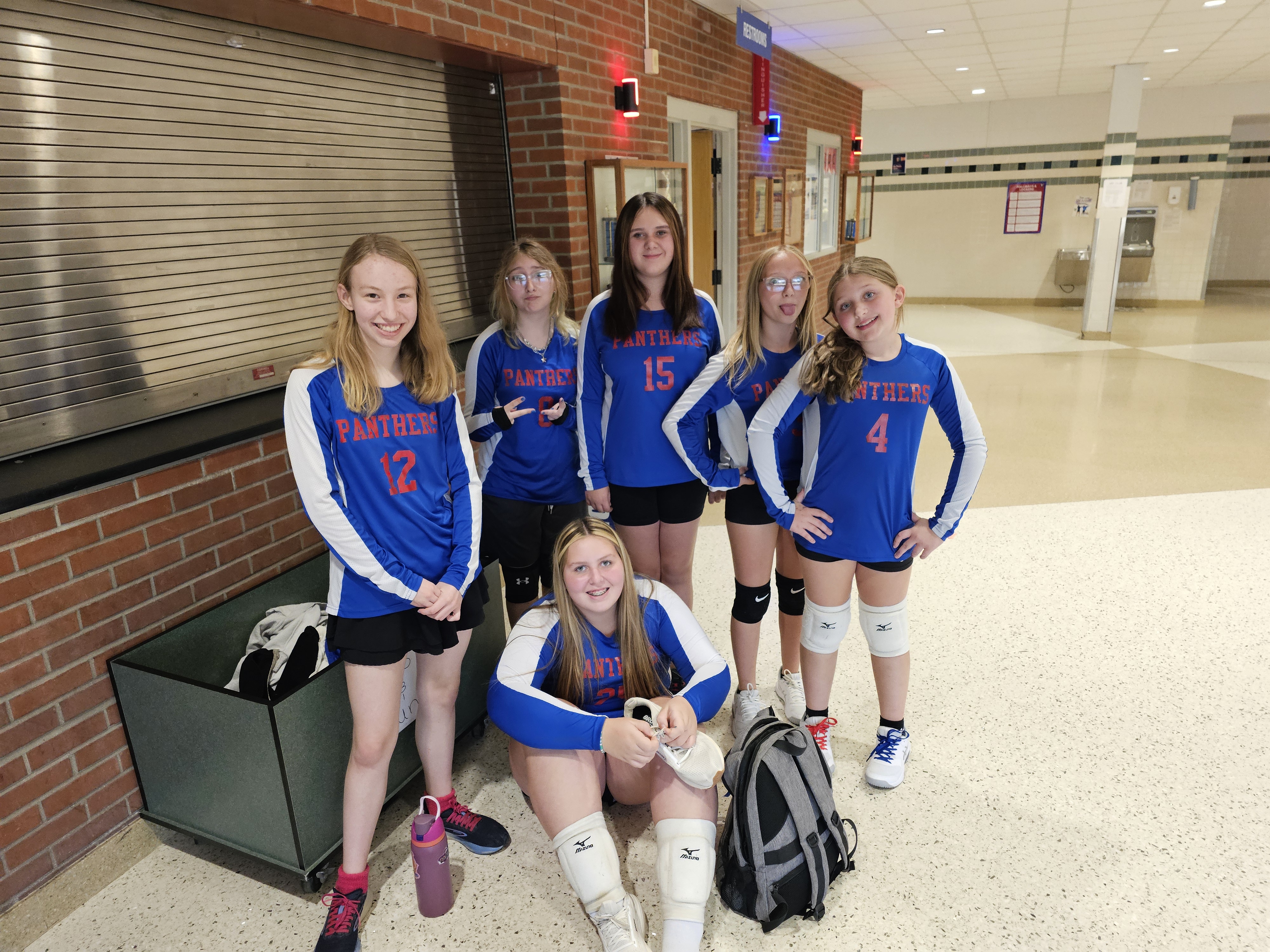 Students posing in blue and white uniforms