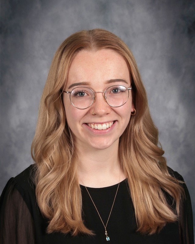 Music teacher with glasses long blond hair