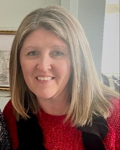 Picture of women with blond hair smile with red sweater