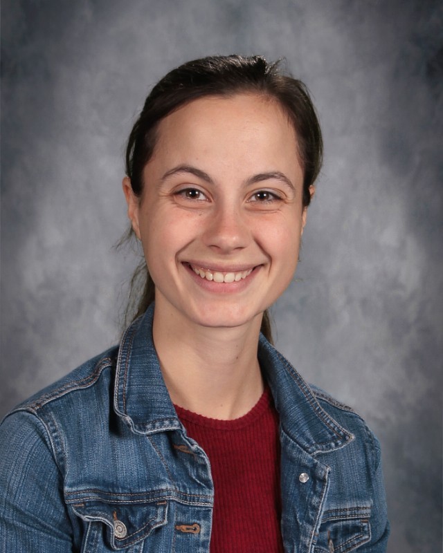 Picture of teacher with smile and jeans jacket