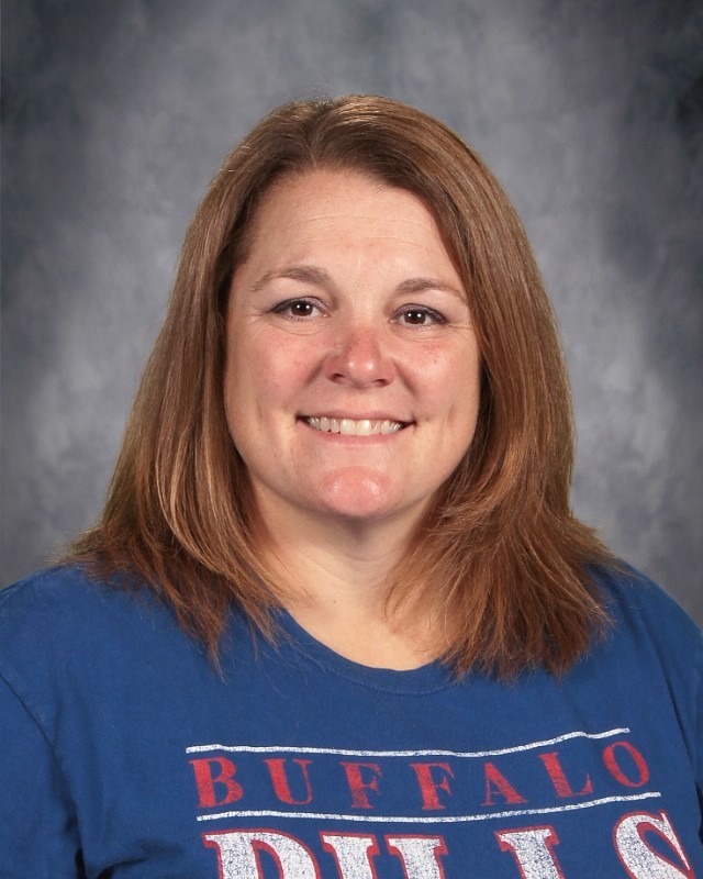 Picture of teacher witth long blond hair grey shirt