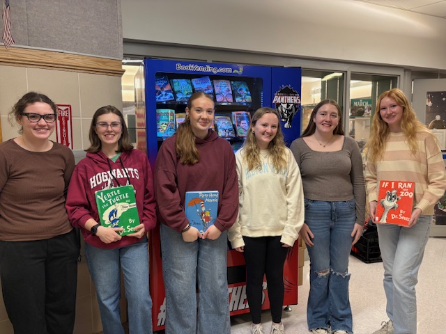 Pictuire of 5 high school students standing with books