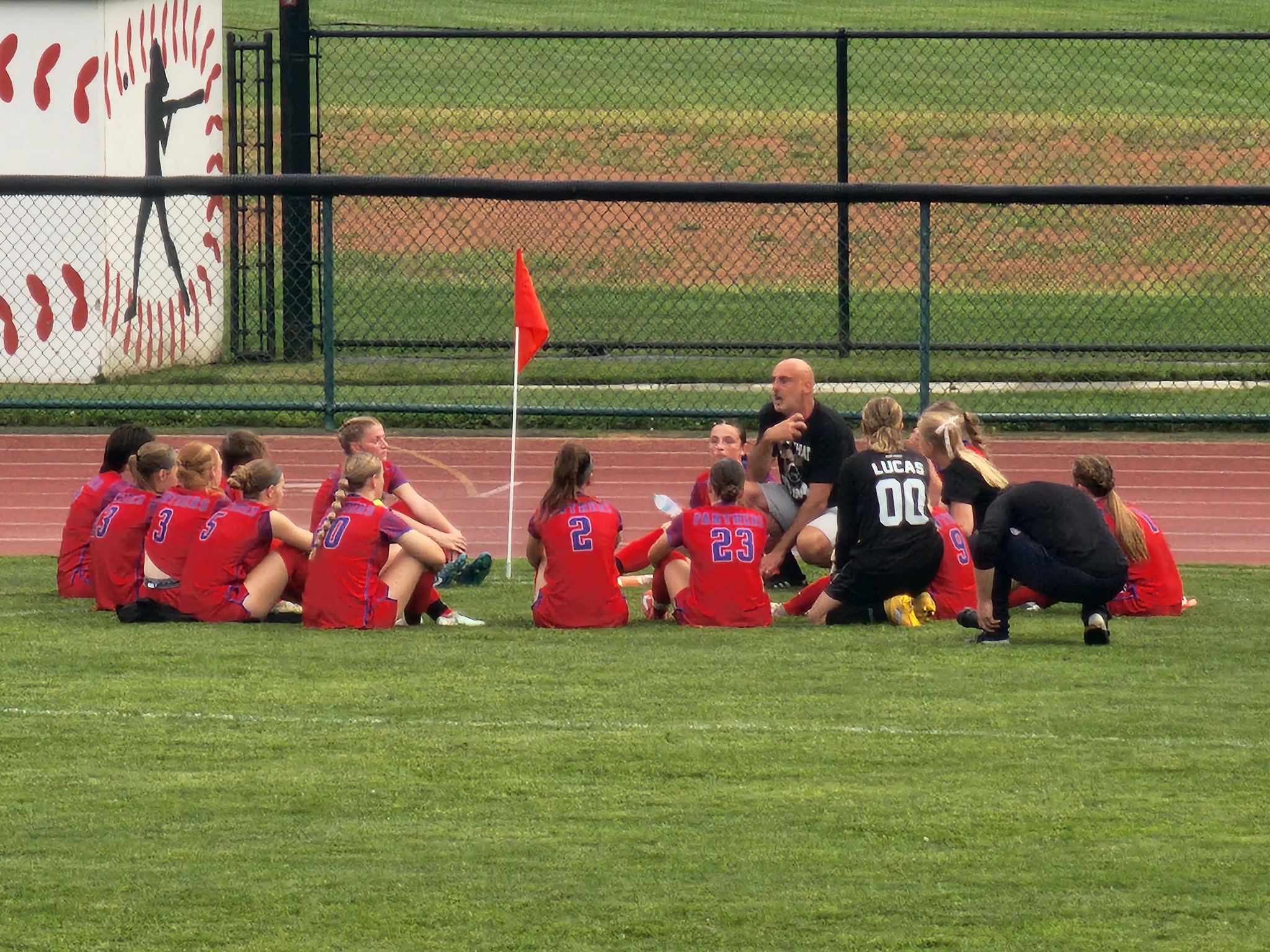 Team on field in red uniforms