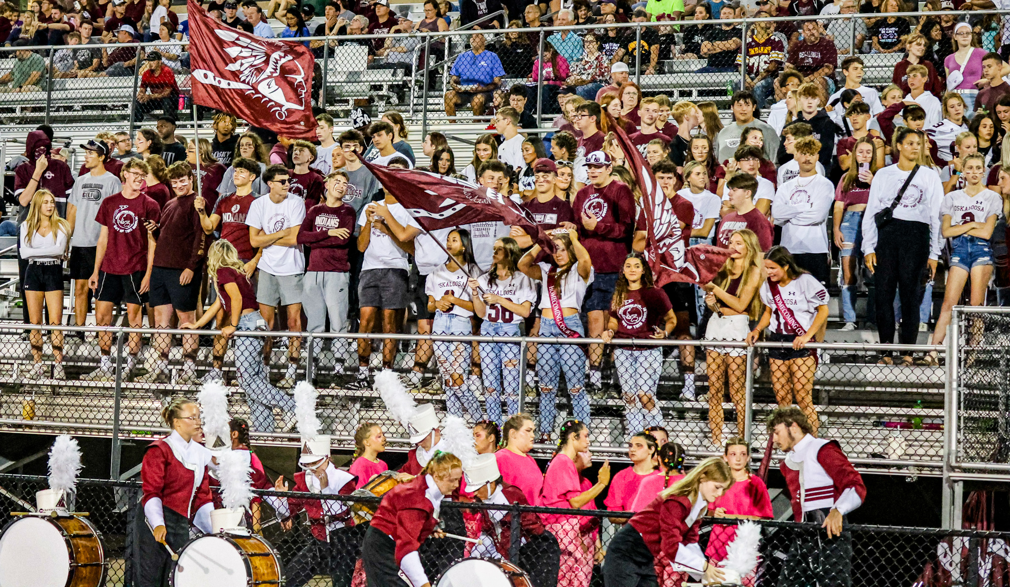 Homecoming photo of students in the stands cheering for their fellow students.