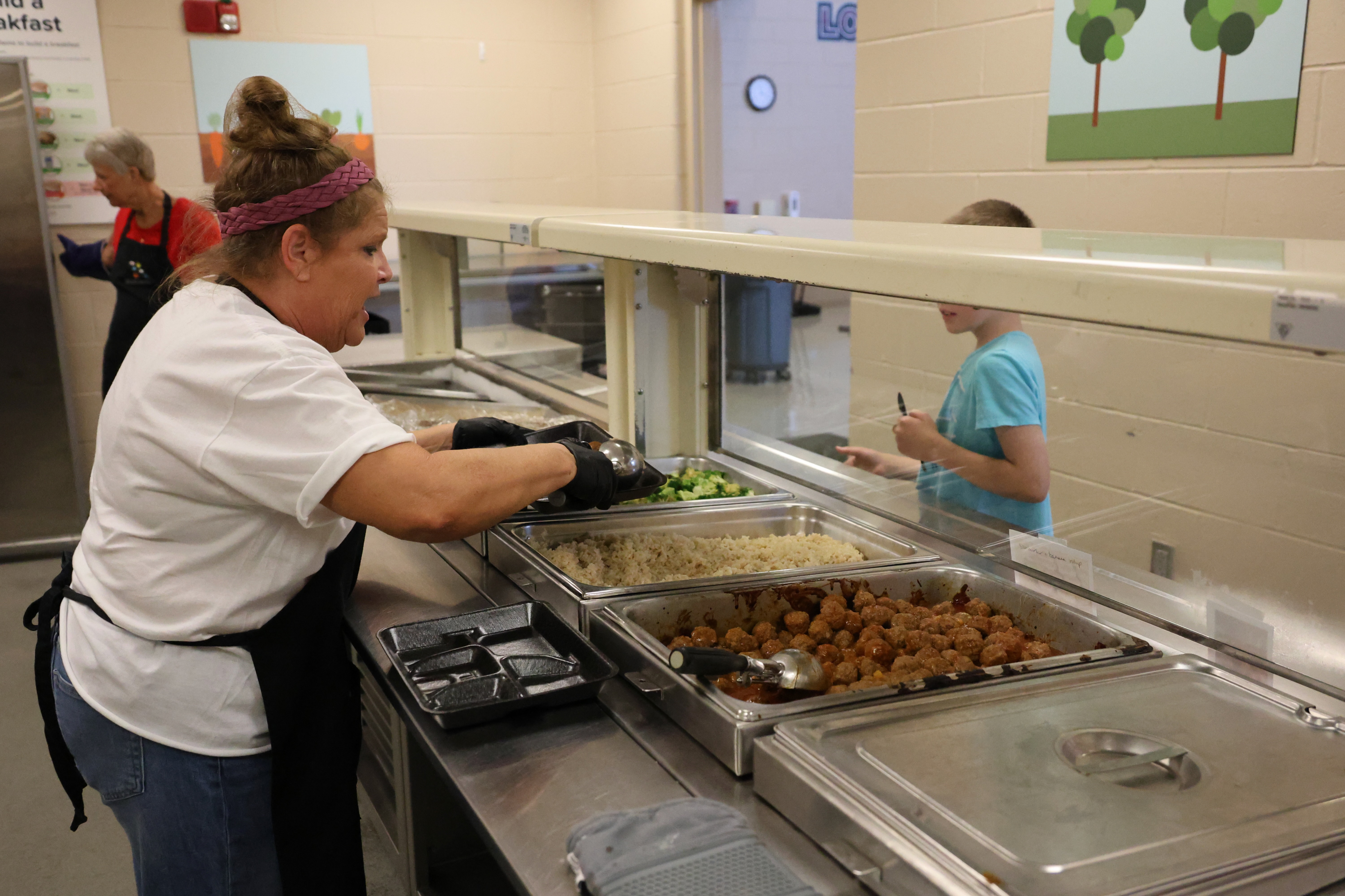 Food Service staff member serving lunch to a student