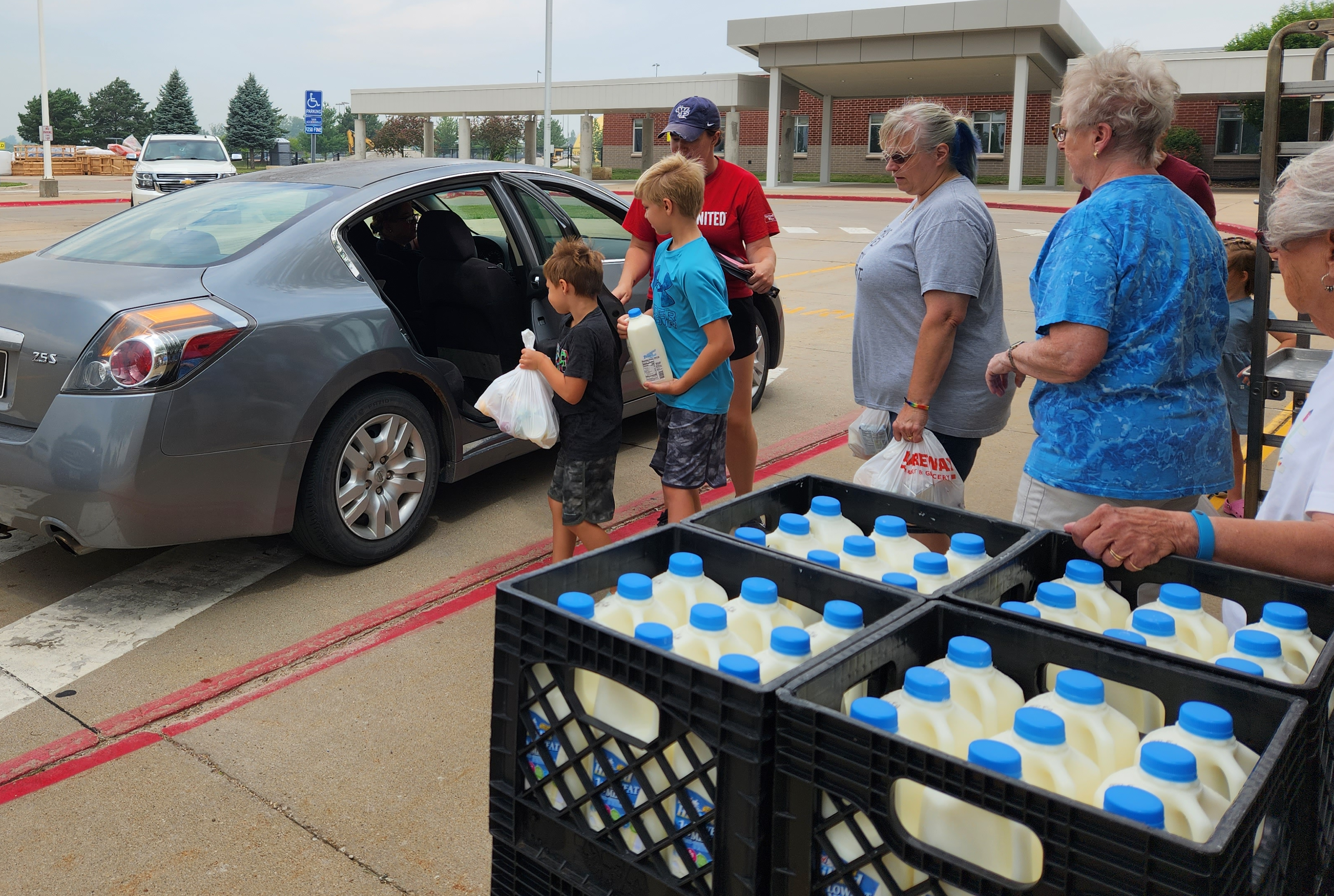 volunteers assisting with the summer lunch program distribution