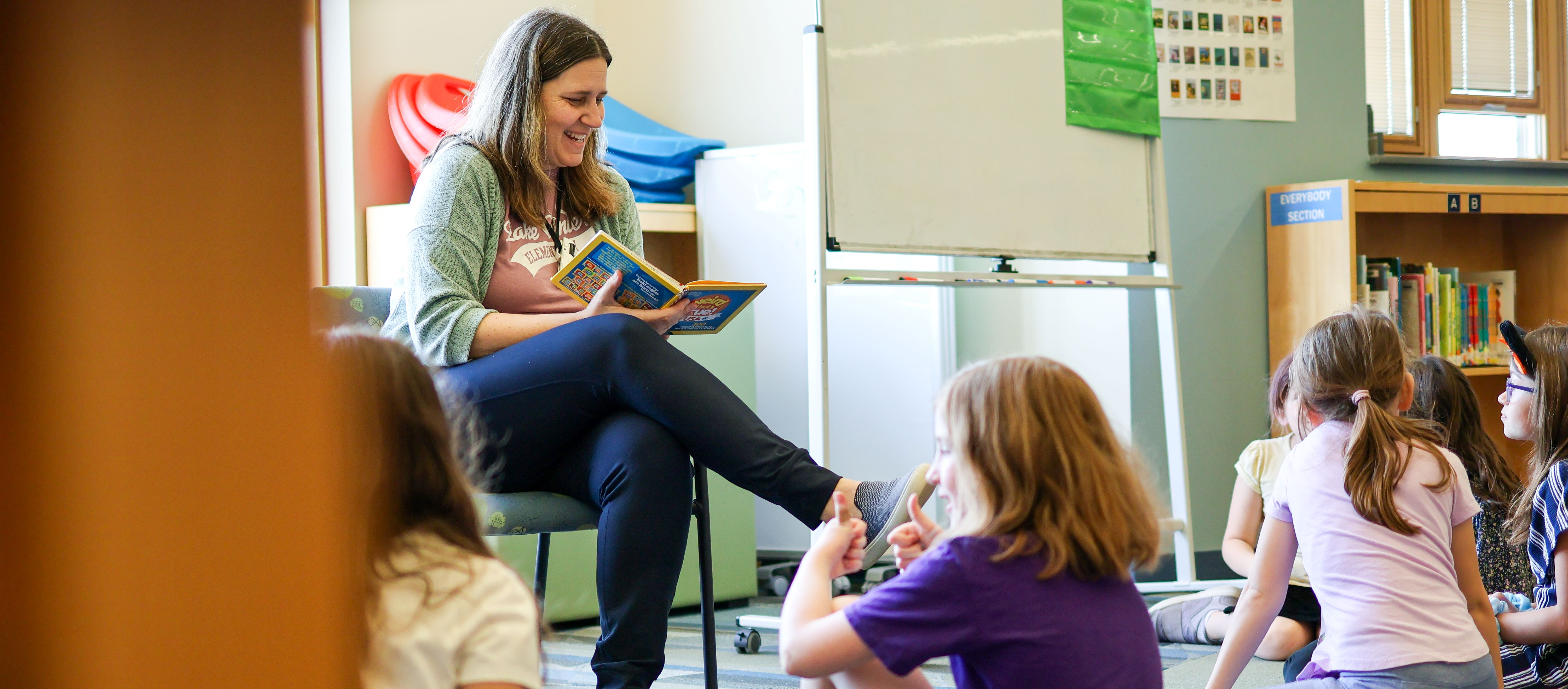 A teacher teaches in the library