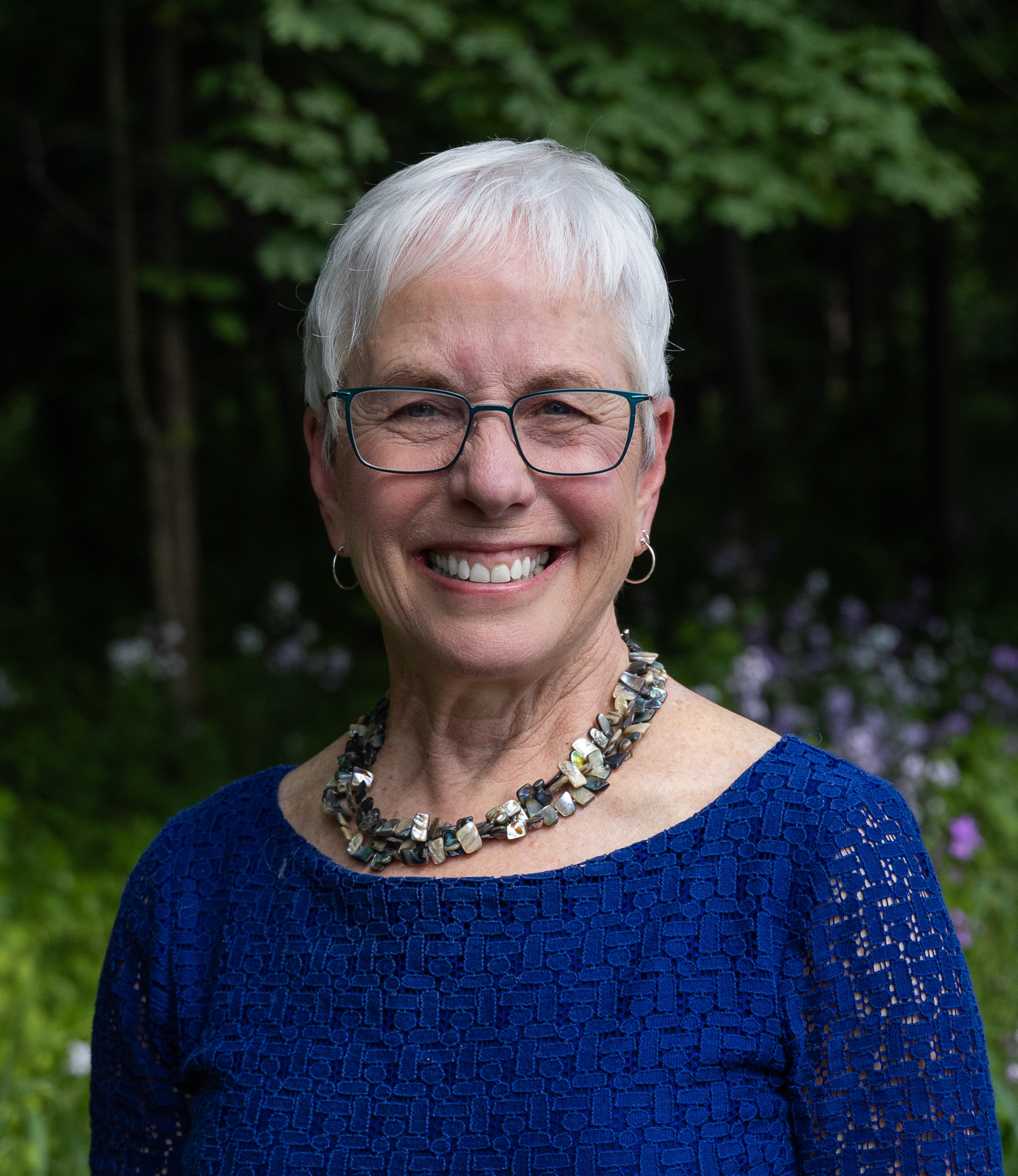 a woman smiles for a portrait