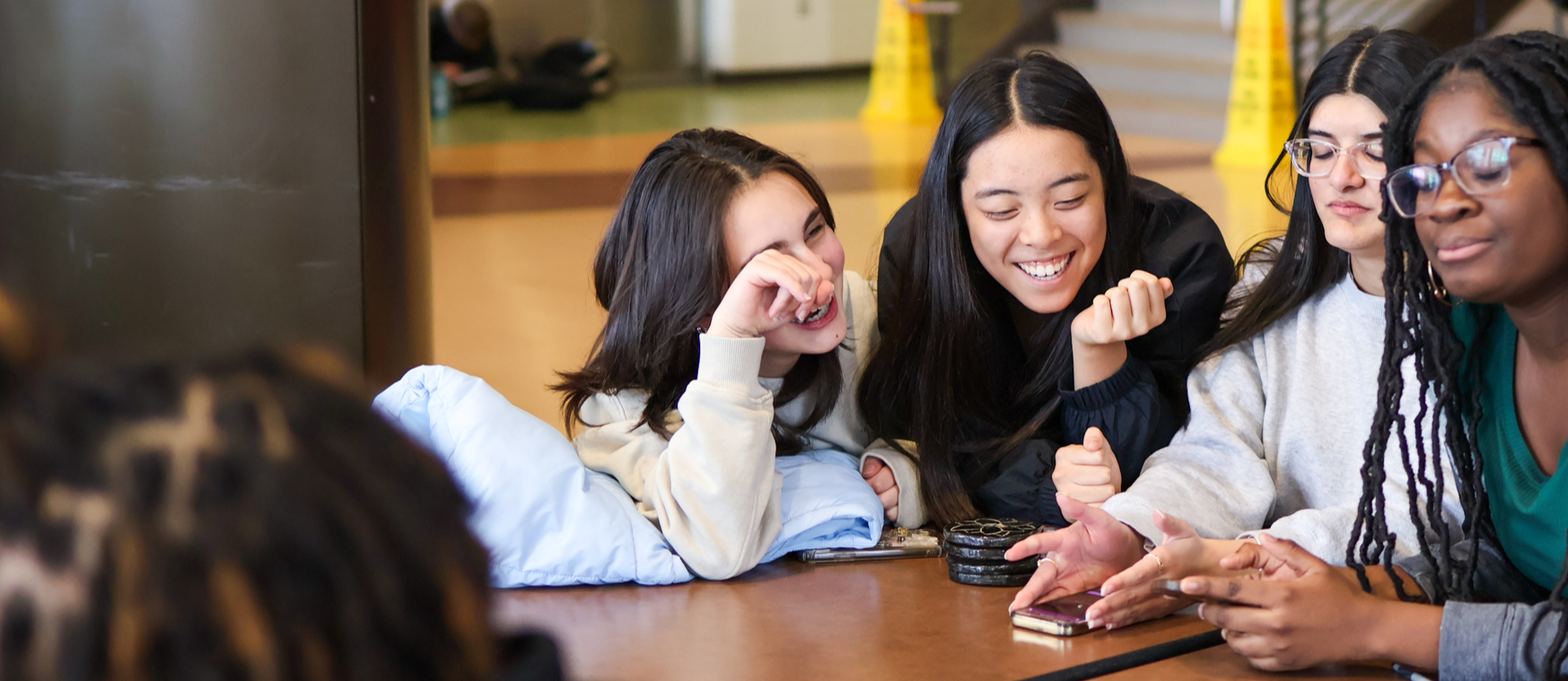 students laugh around a lunch table