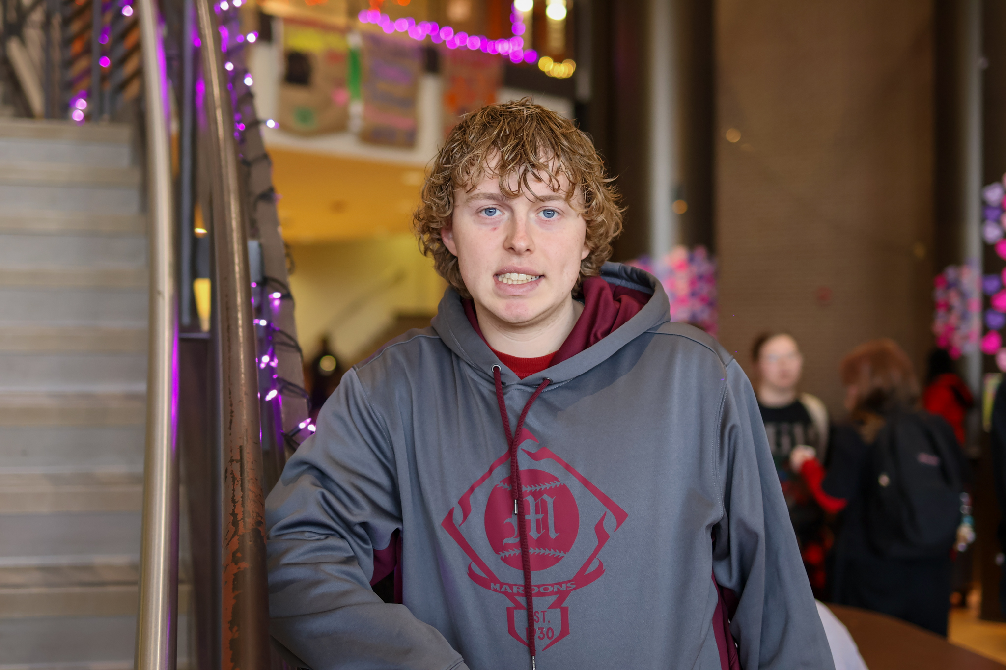 a man stands in a cafeteria