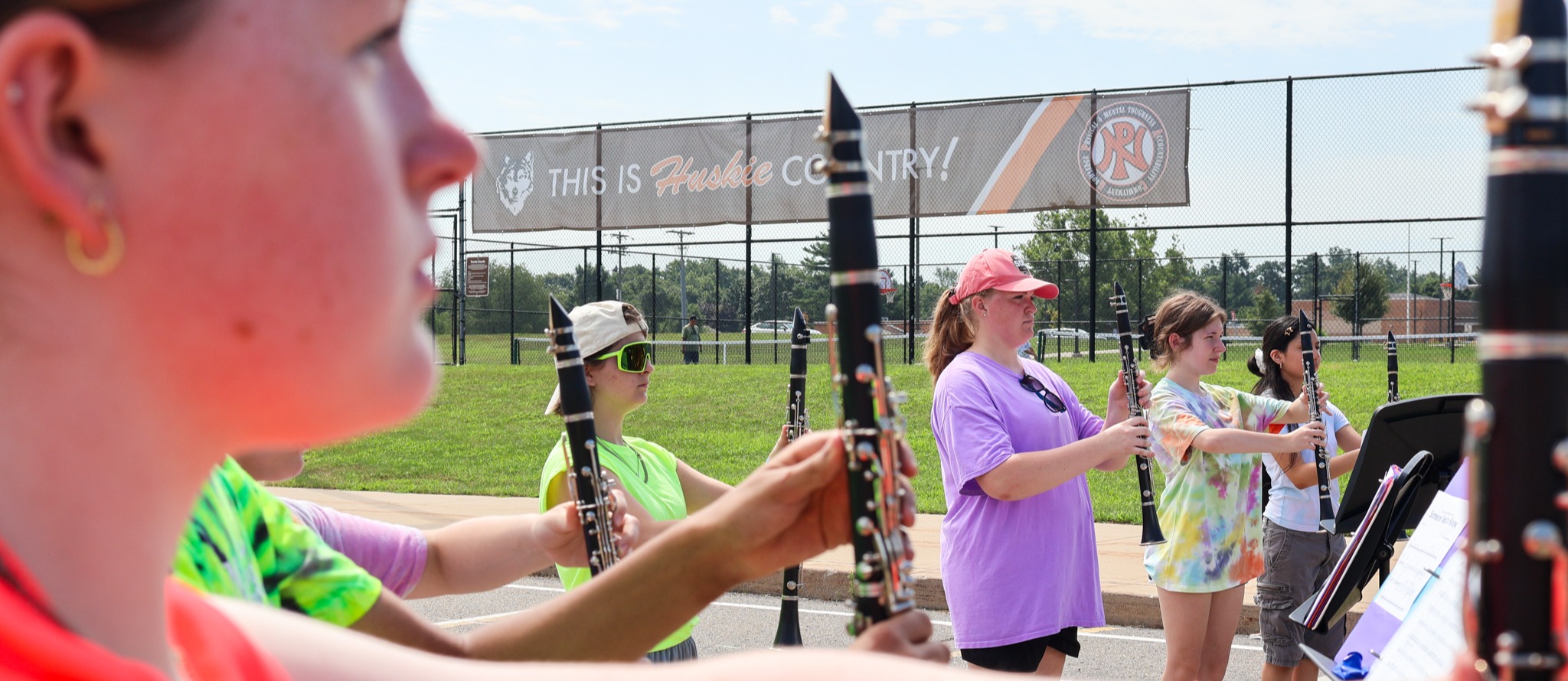 students standing at attention with clarinets