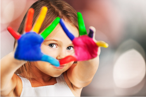 Little girl with hands painted in multiple colors