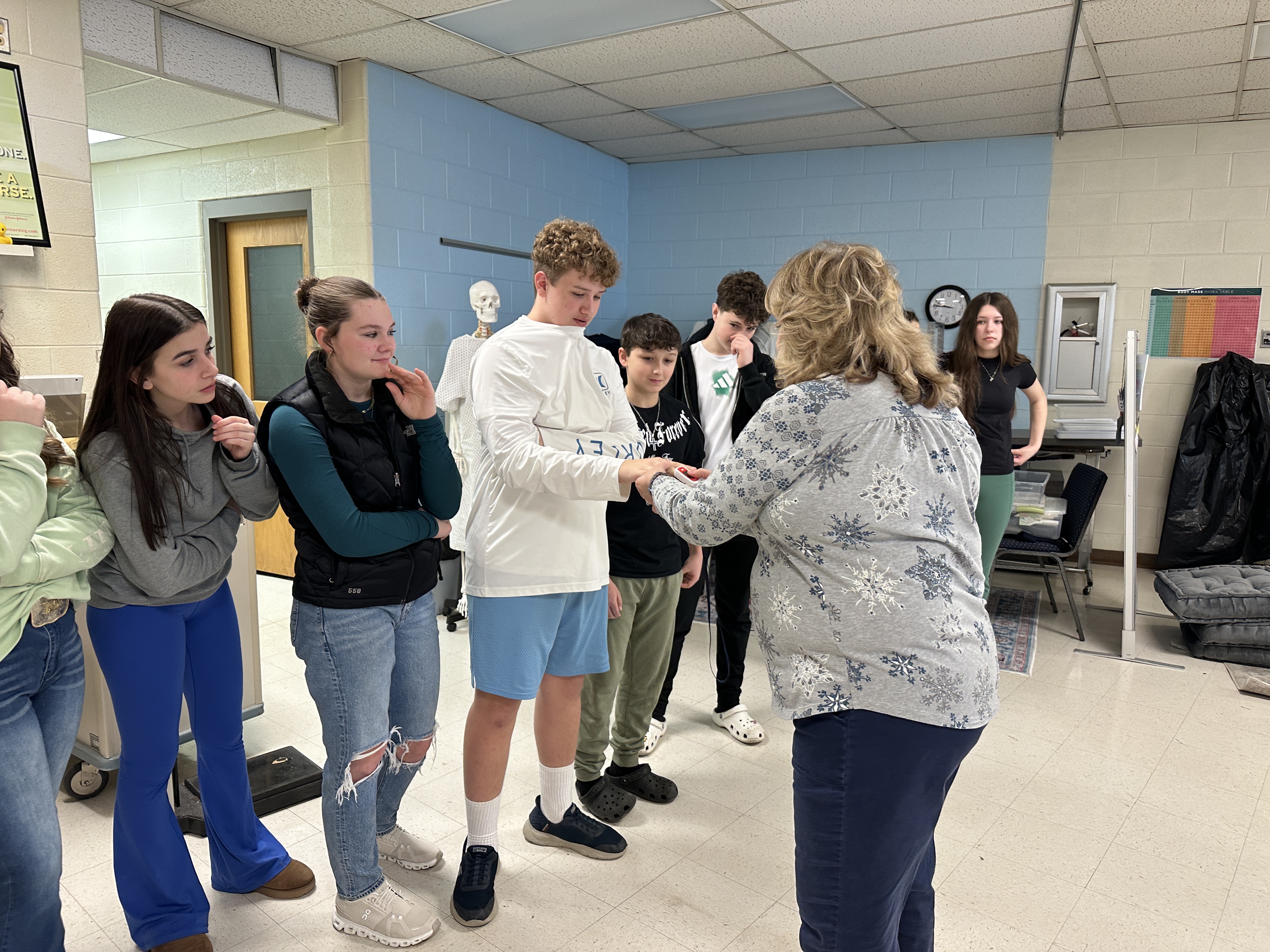 Students have their pulse checked by a nurse.