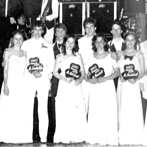 1980s Prom. group of people in suits and dresses holding up signs