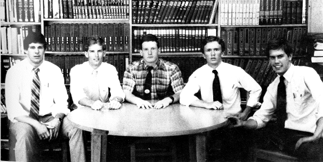 1985 Student Council sitting around a table