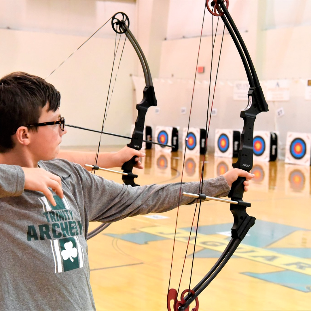 student shooting their bow and arrow