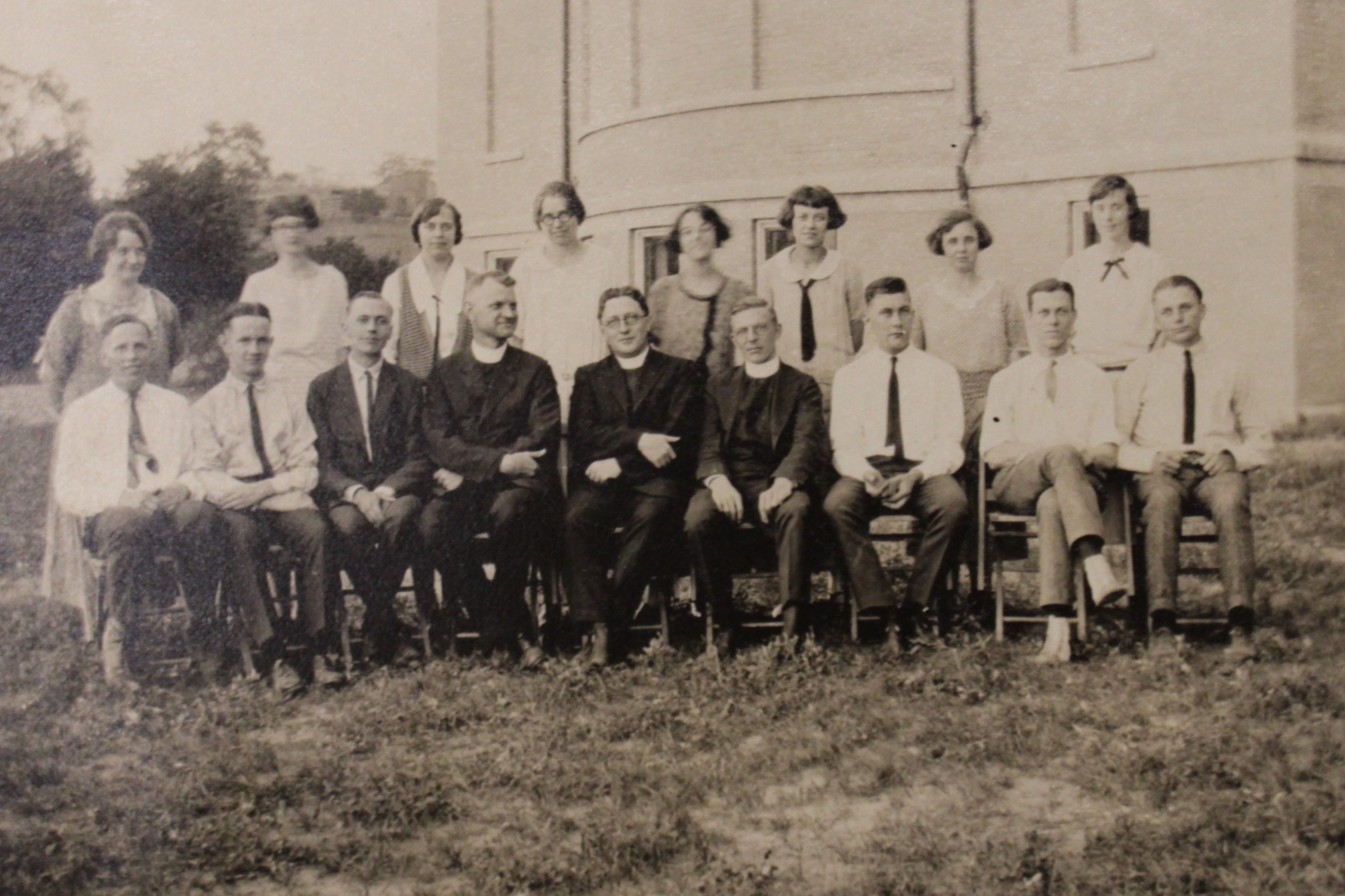 Photo of group of students in front of school.