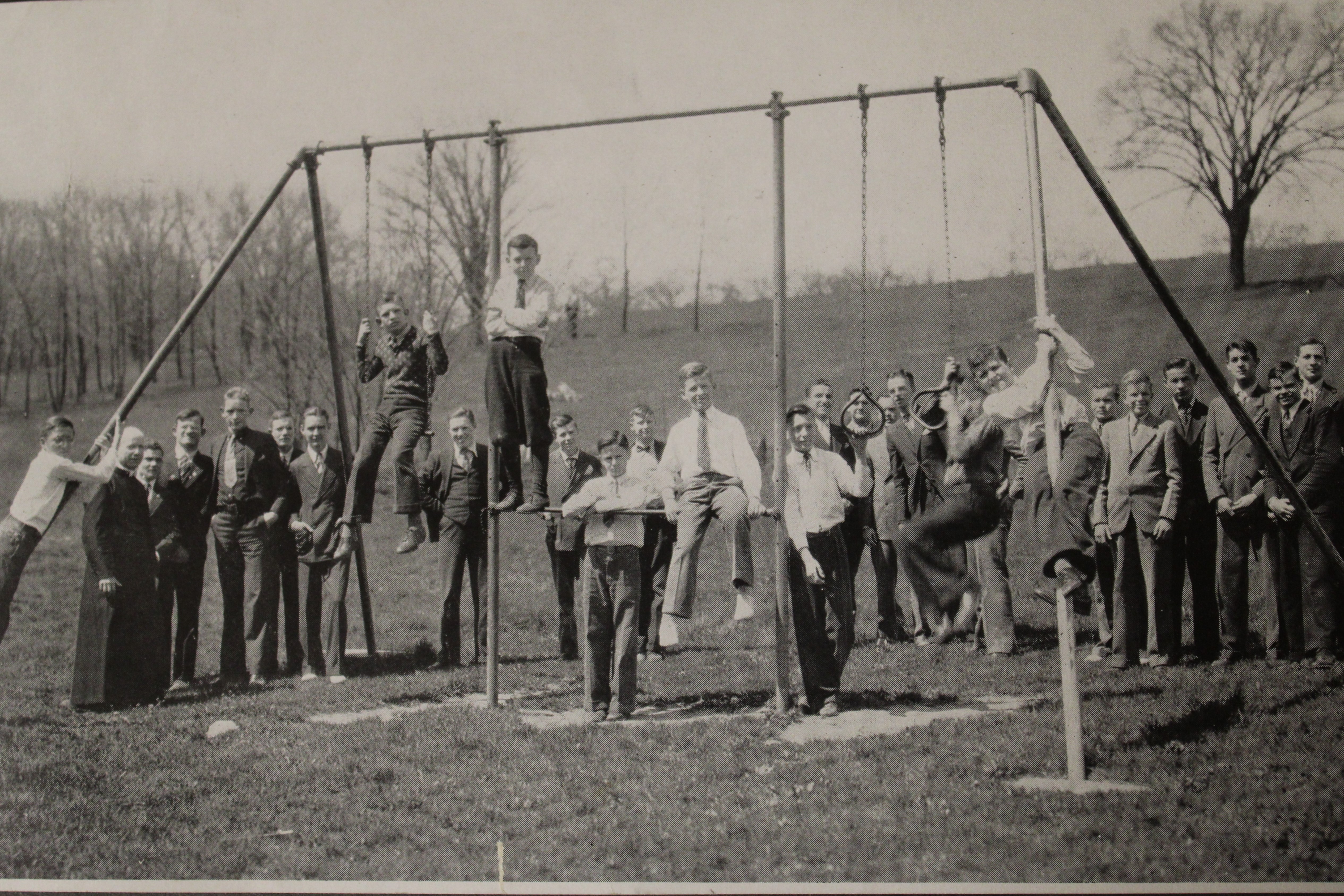 Children next to a swing set. 