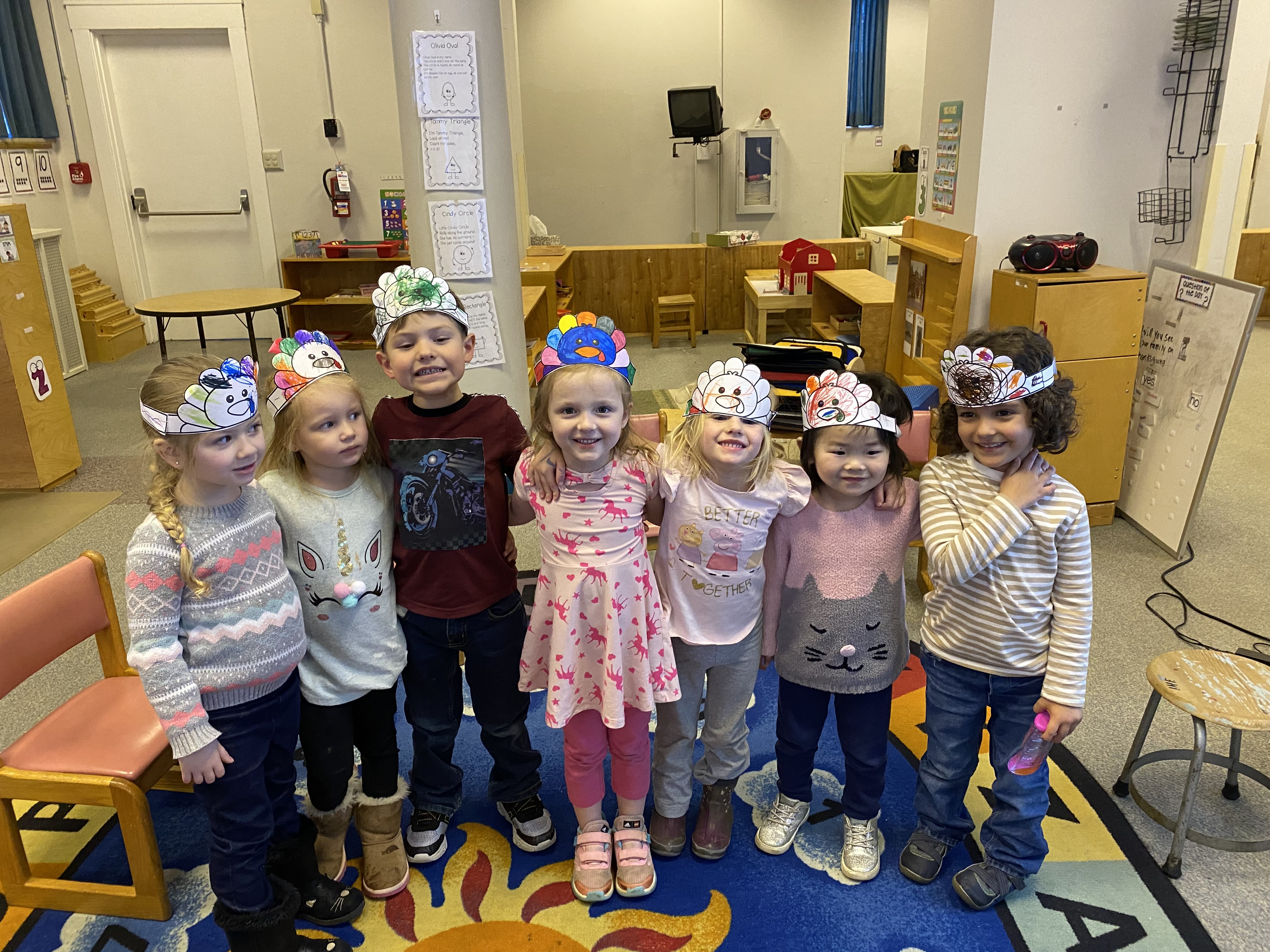 6 children wearing headbands they colored.