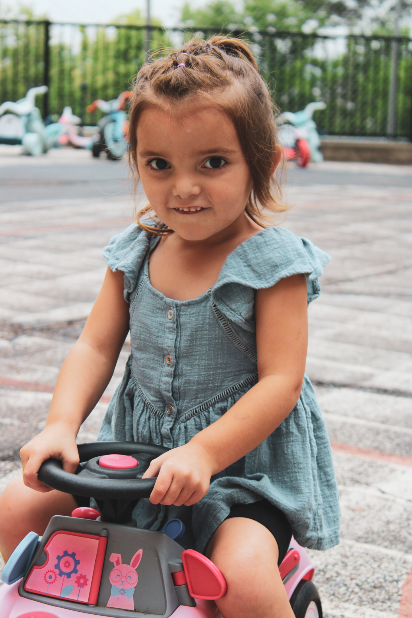 A child smiling in the playground. 