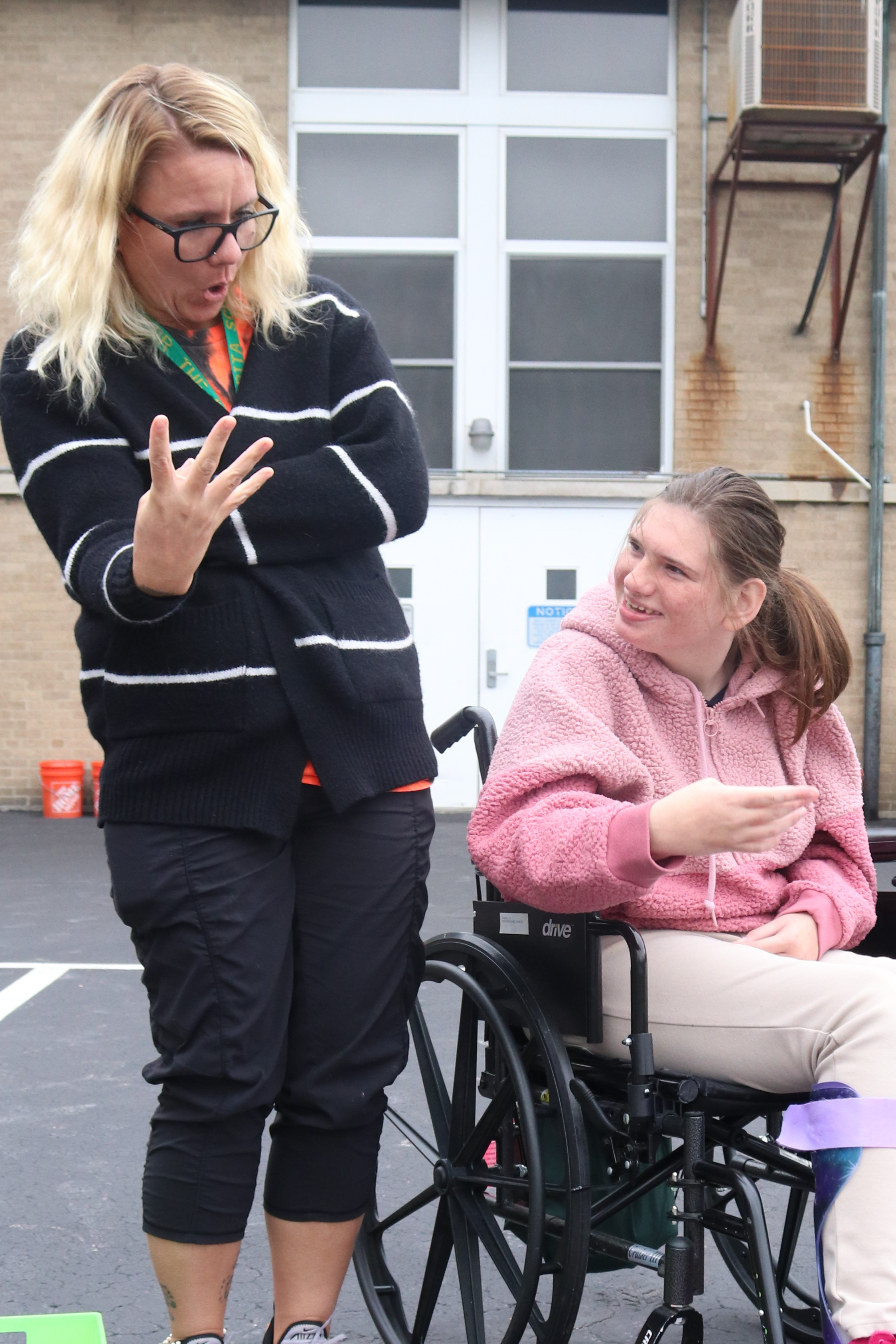a high school staff with a female student with wheelchair