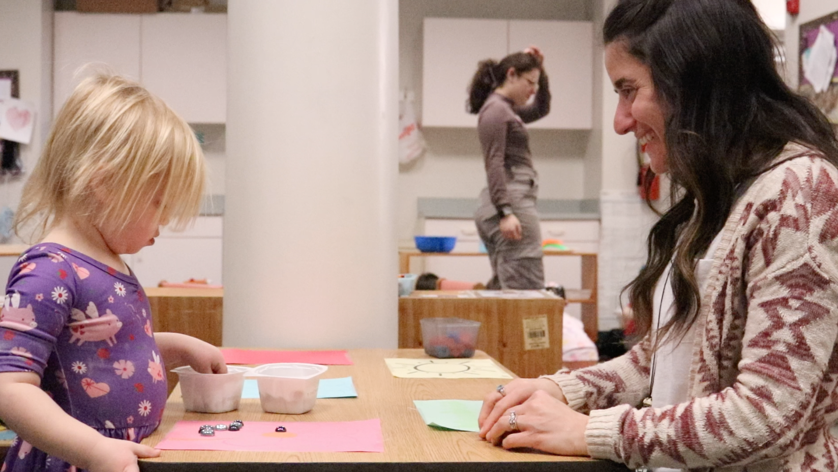 preschool student working with a teacher