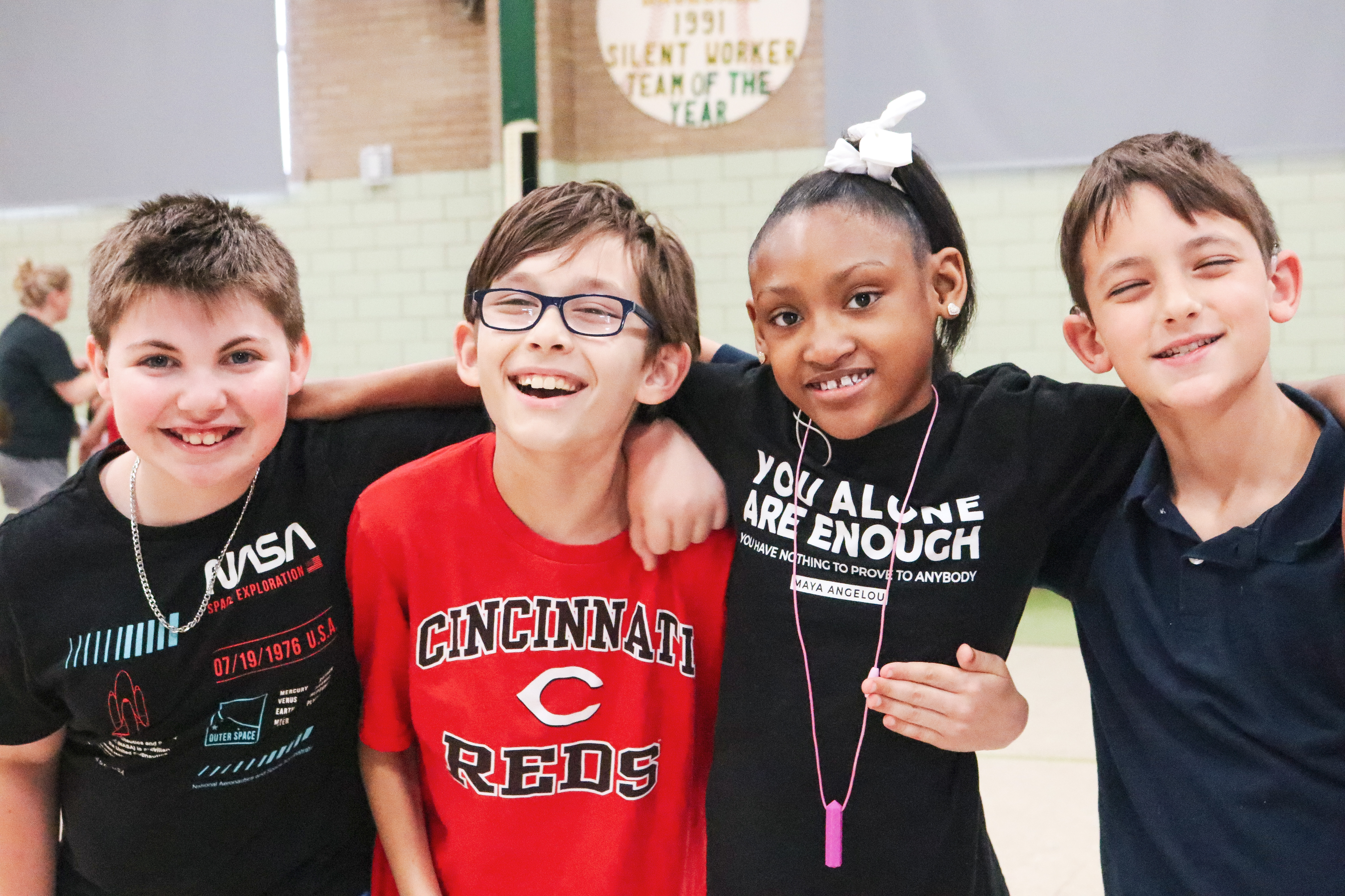 4 students smiling at the gym