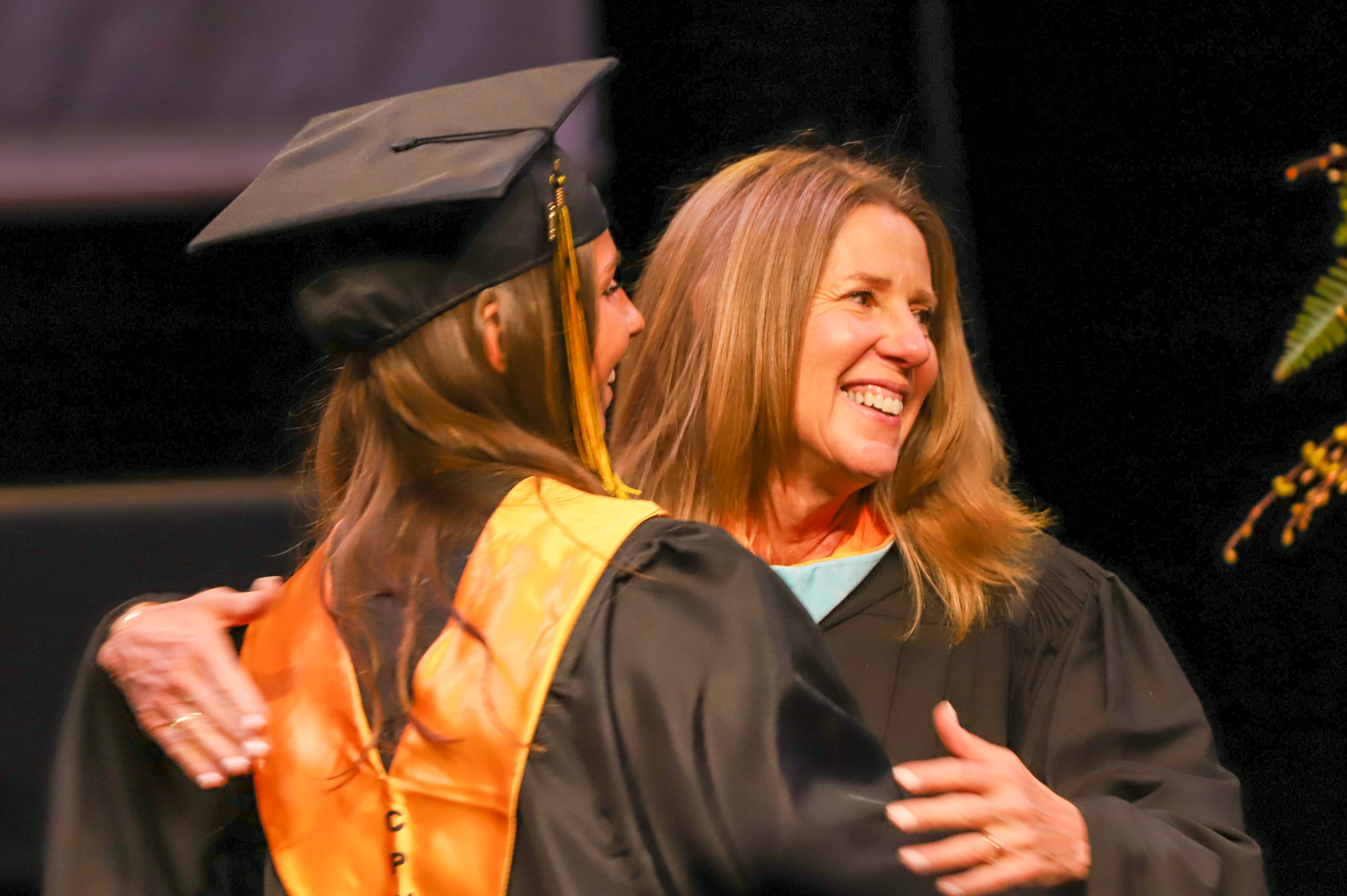 Superintendent Sherry Durkee hugging a student at graduation