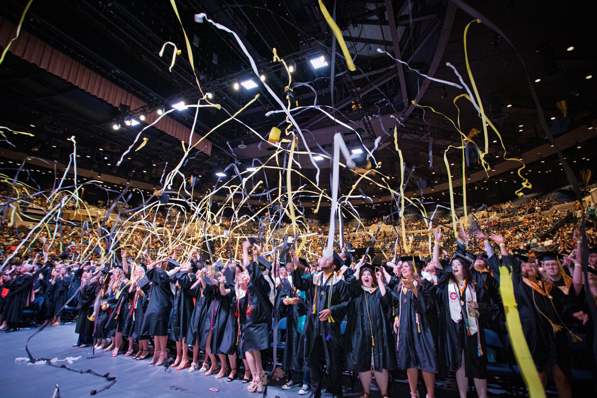 Graduates throwing streamers in the air