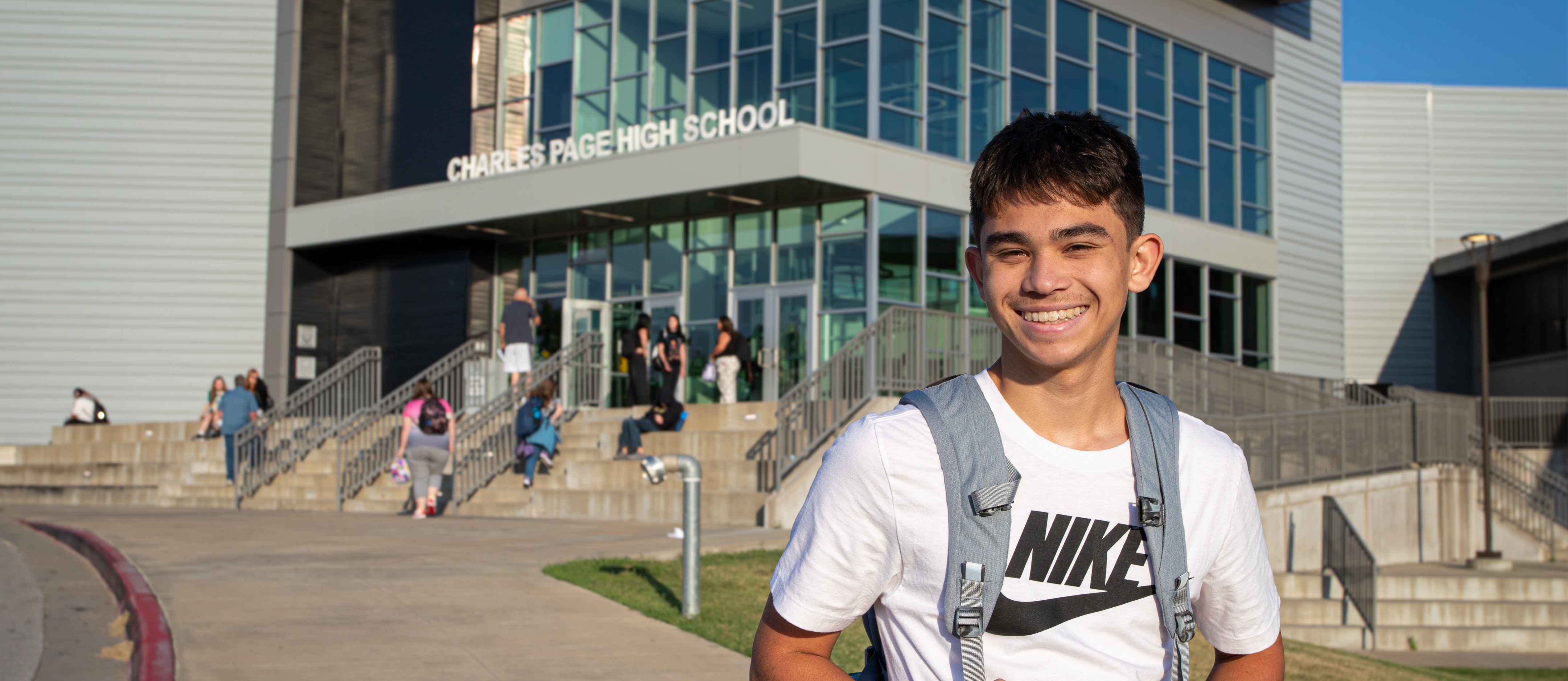 Teenage boy in front of Charles Page High School