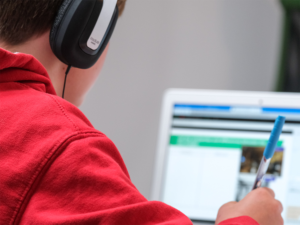 boy looking at computer