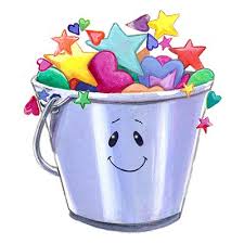 A bucket with a smiley face on it that contains stars overflowing out of the top