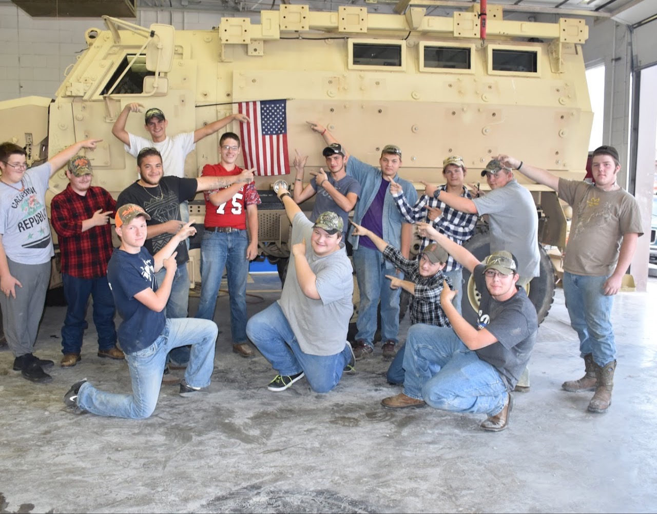 Students pointing at a flag