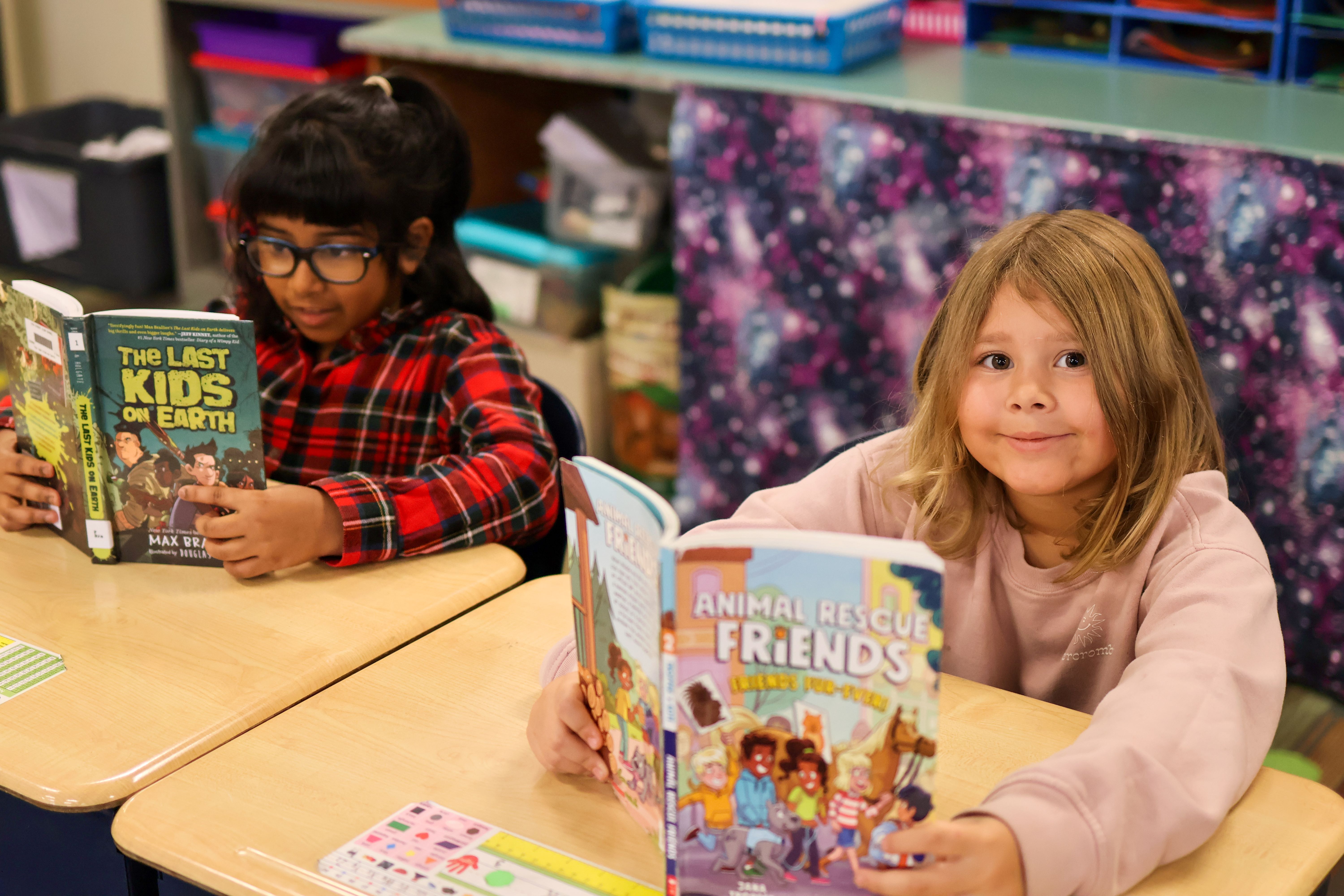 two students reading at desks