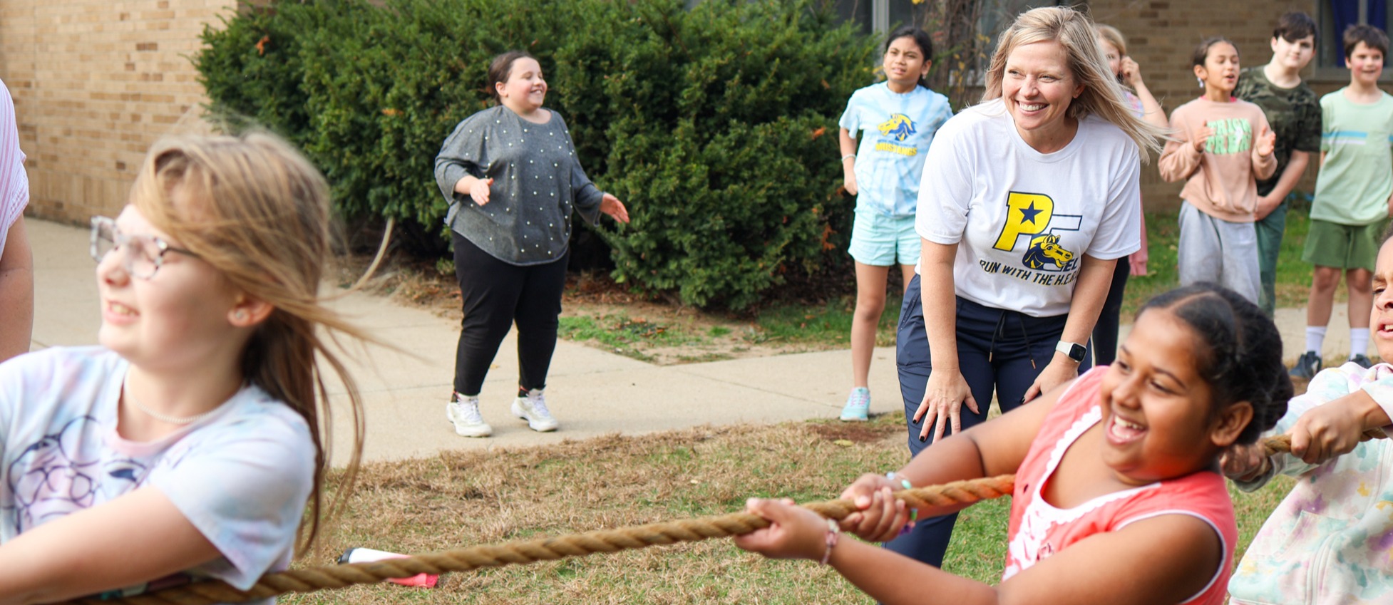 students play tug of war outside