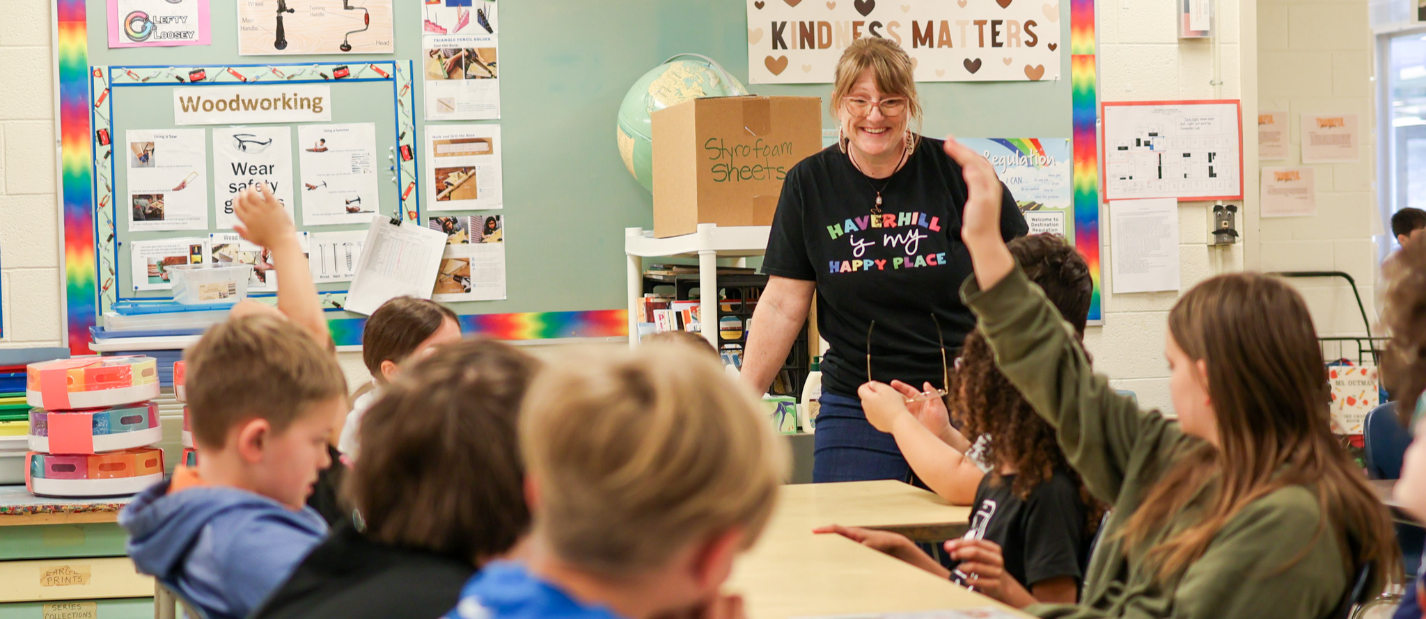 a teacher smiles at her classroom of students