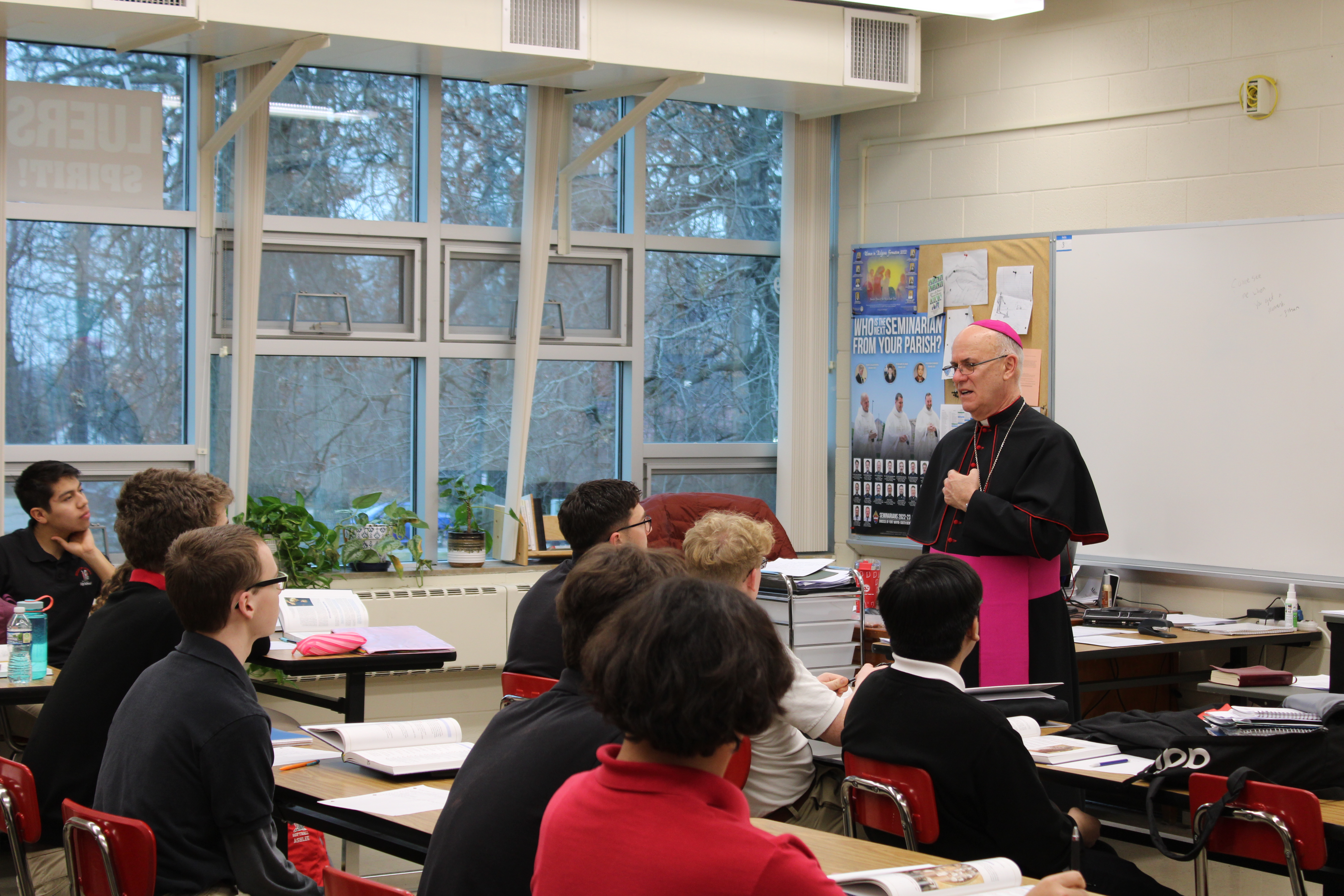 Bishop Rhoades talking with classroom