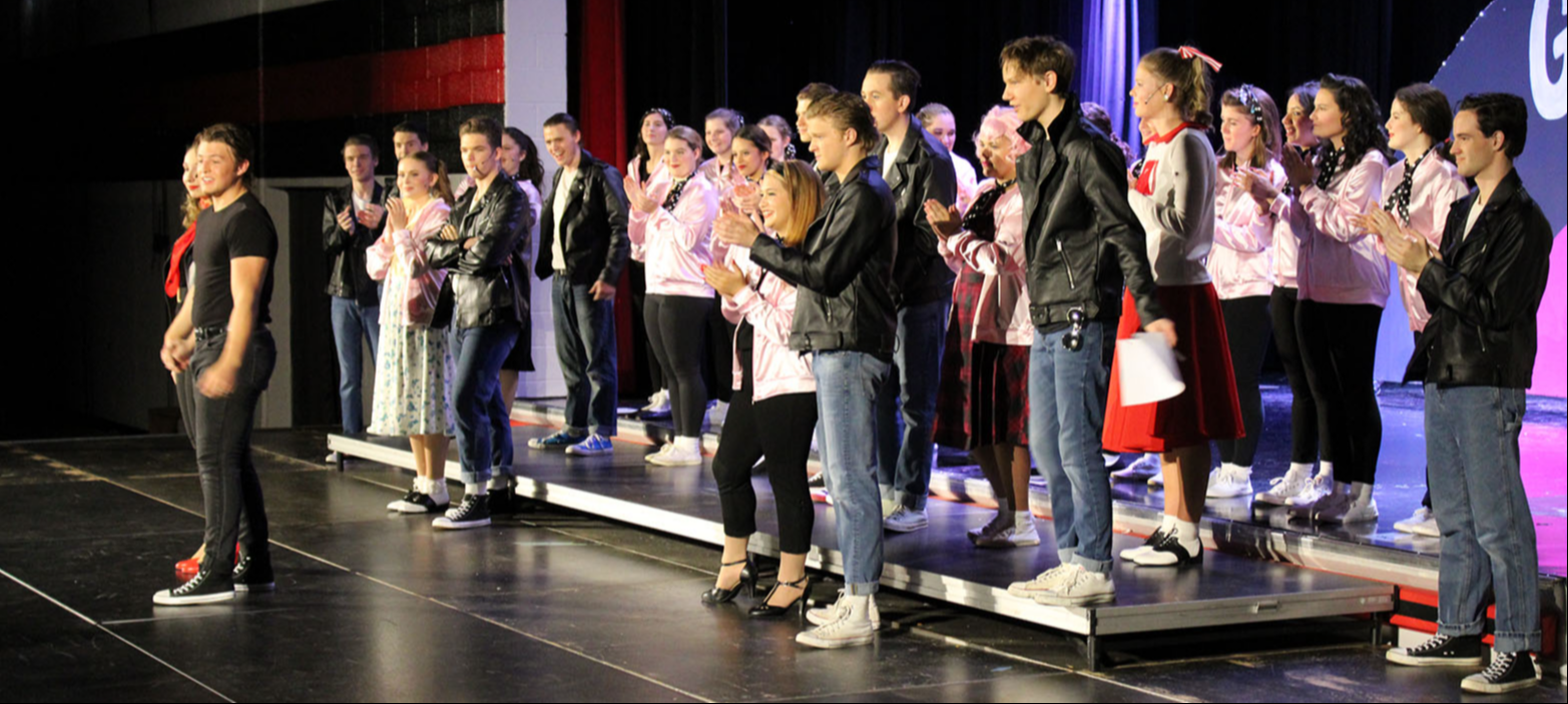 students in brightly colored costumes for a school production