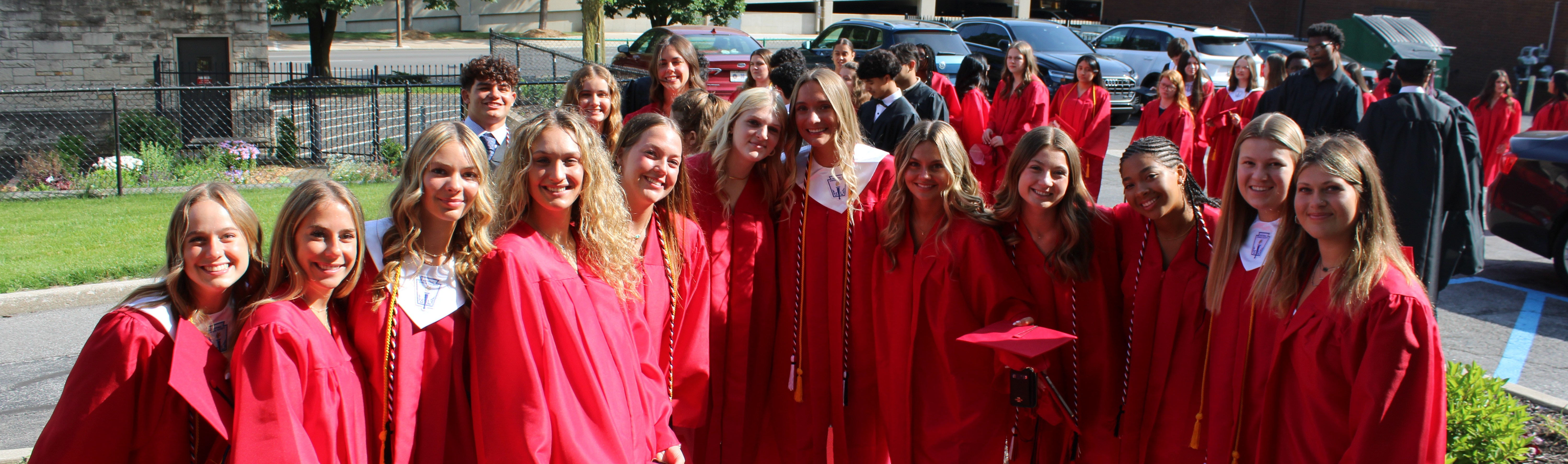 students in graduation caps and downs smiling