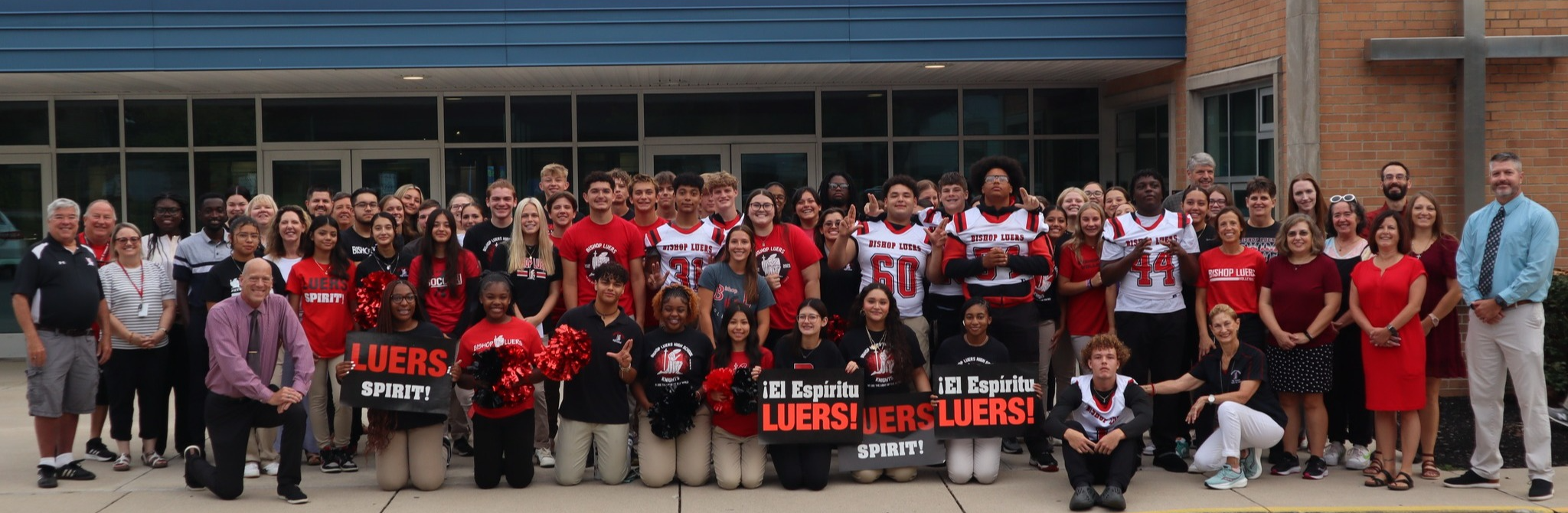 Smiling Luers students with a "Tours Start Here" sign