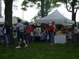 people standing in line leading up to a tent