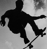 A man on a skateboard that is a silhouette 