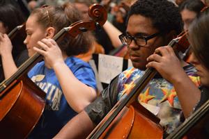 Students playing chello at concert