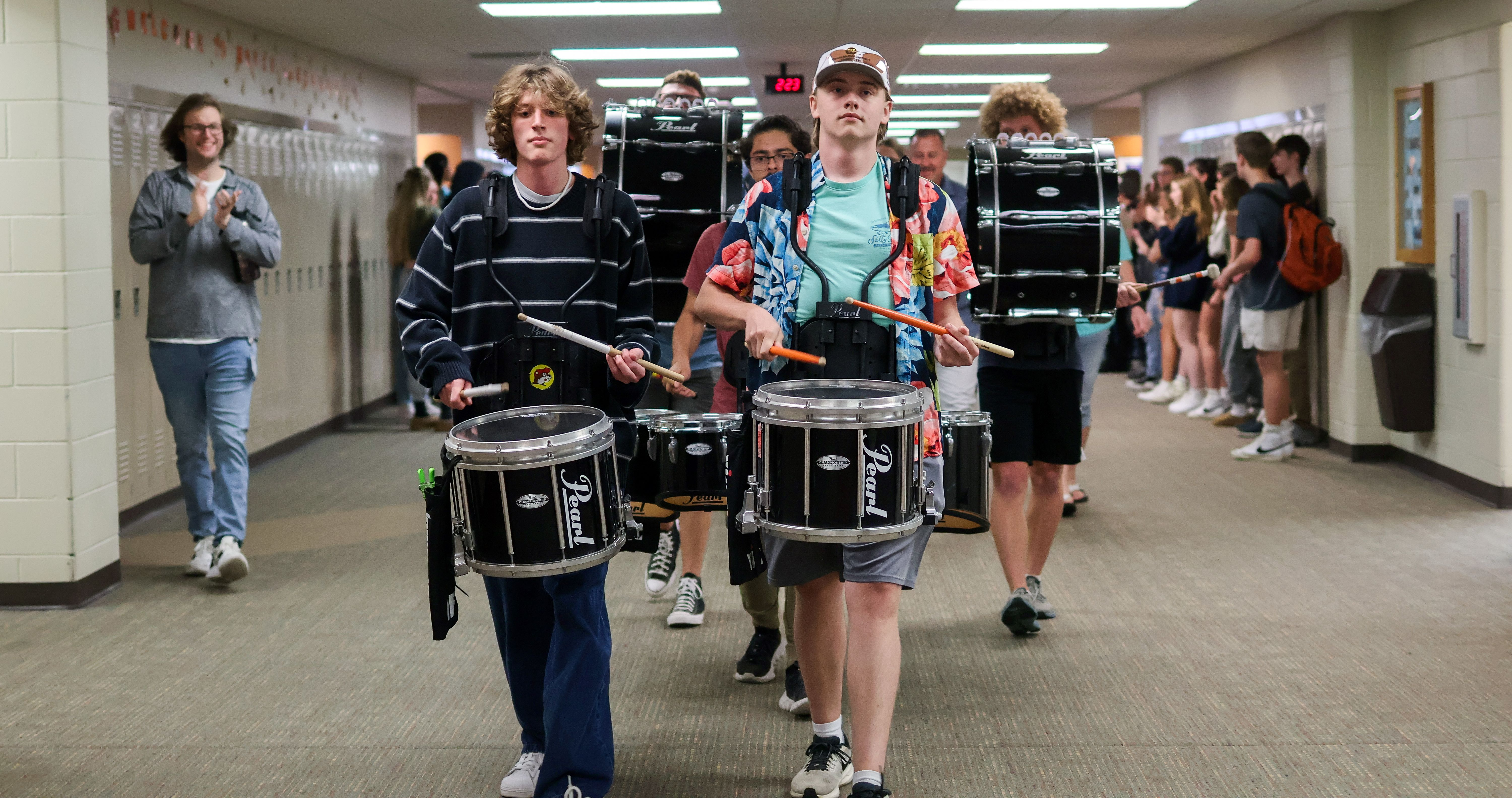 students play in the drumline inside the school