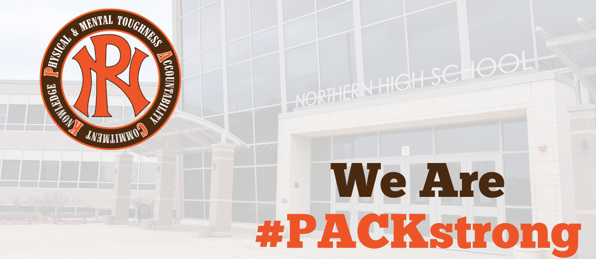 front of the school building with WE ARE PACKSTRONG and PN Packstrong logo