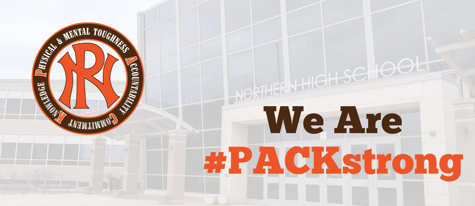 front of the school building with WE ARE PACKSTRONG and PN Packstrong logo