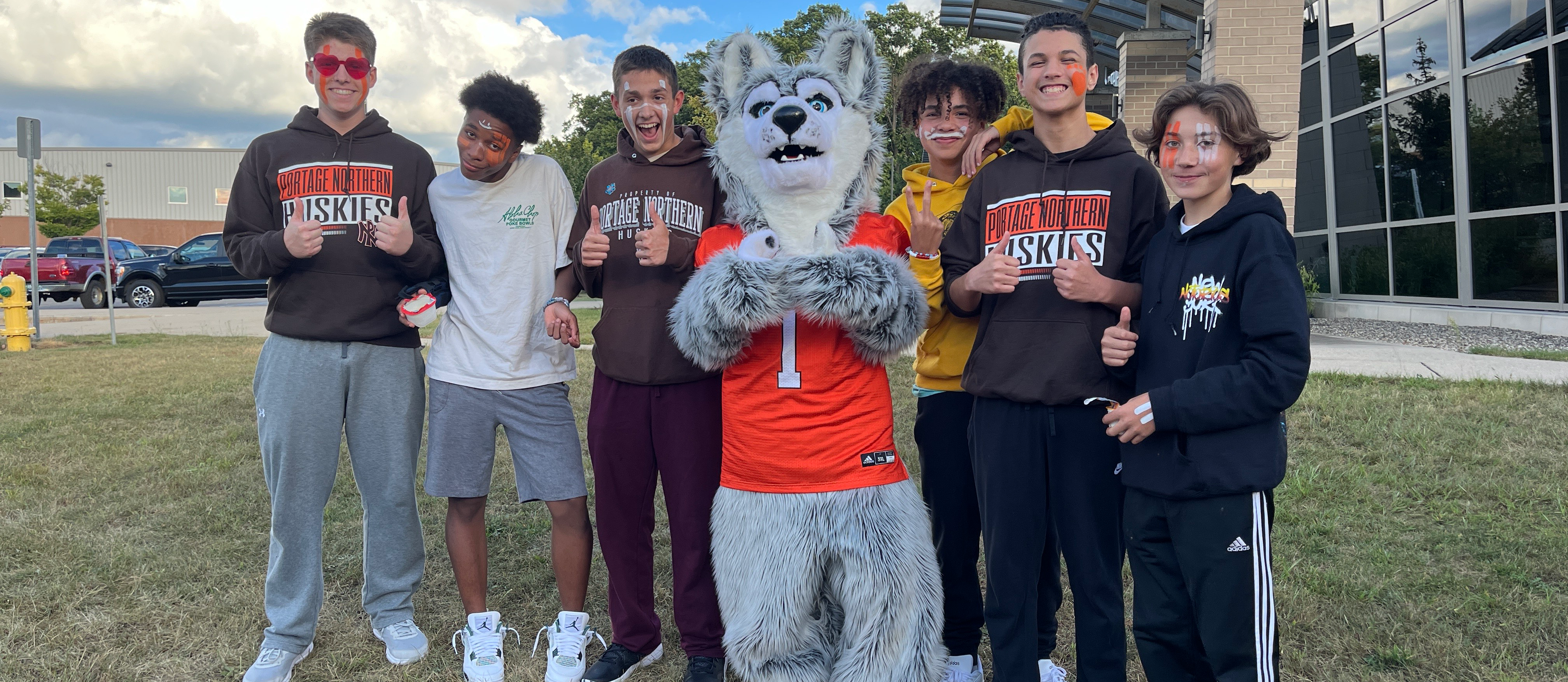 students with Hutch the Huskie at the freshman tailgate before  a football game