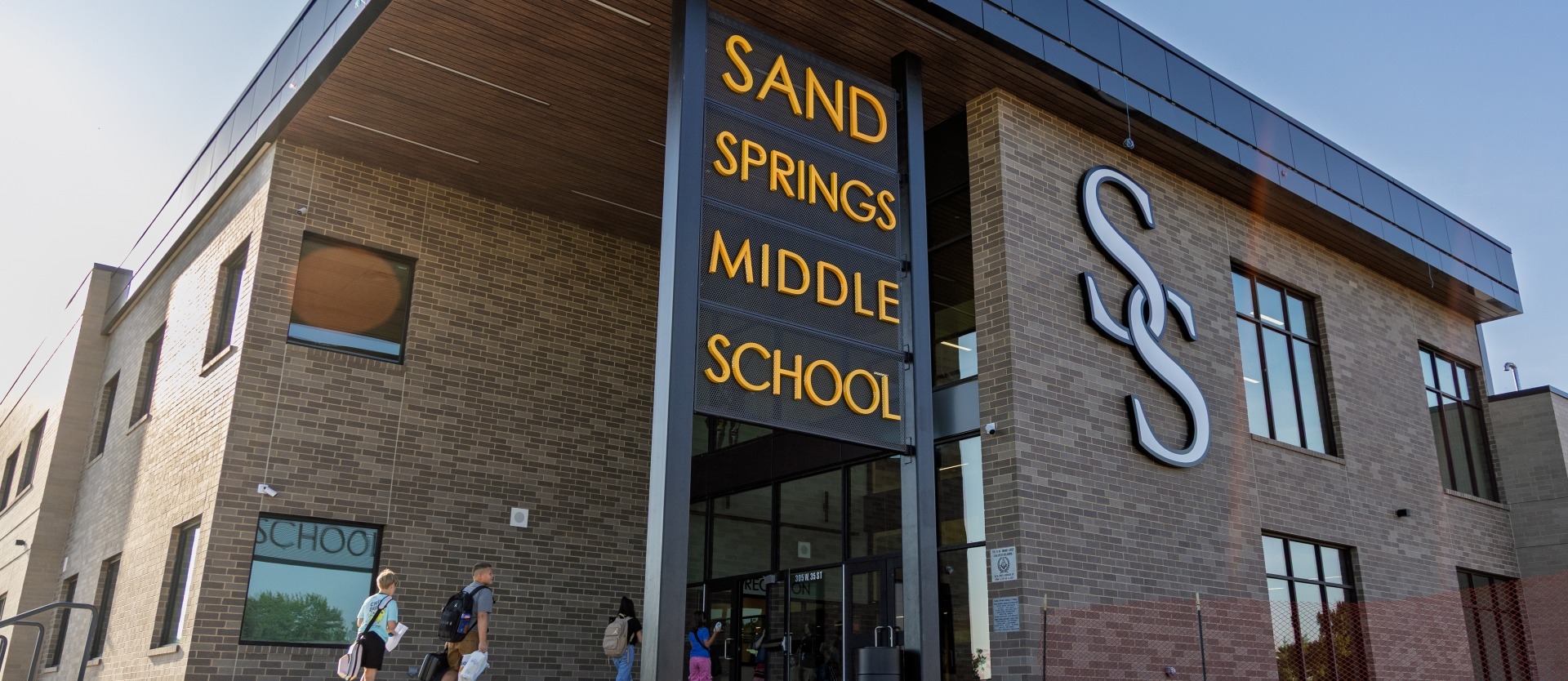 Sand Springs Middle Schools modern brick entrance and large "SS" logo.