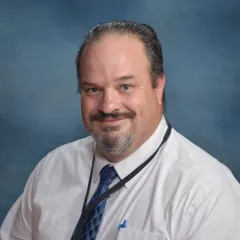 headshot of assistant principal on blue background