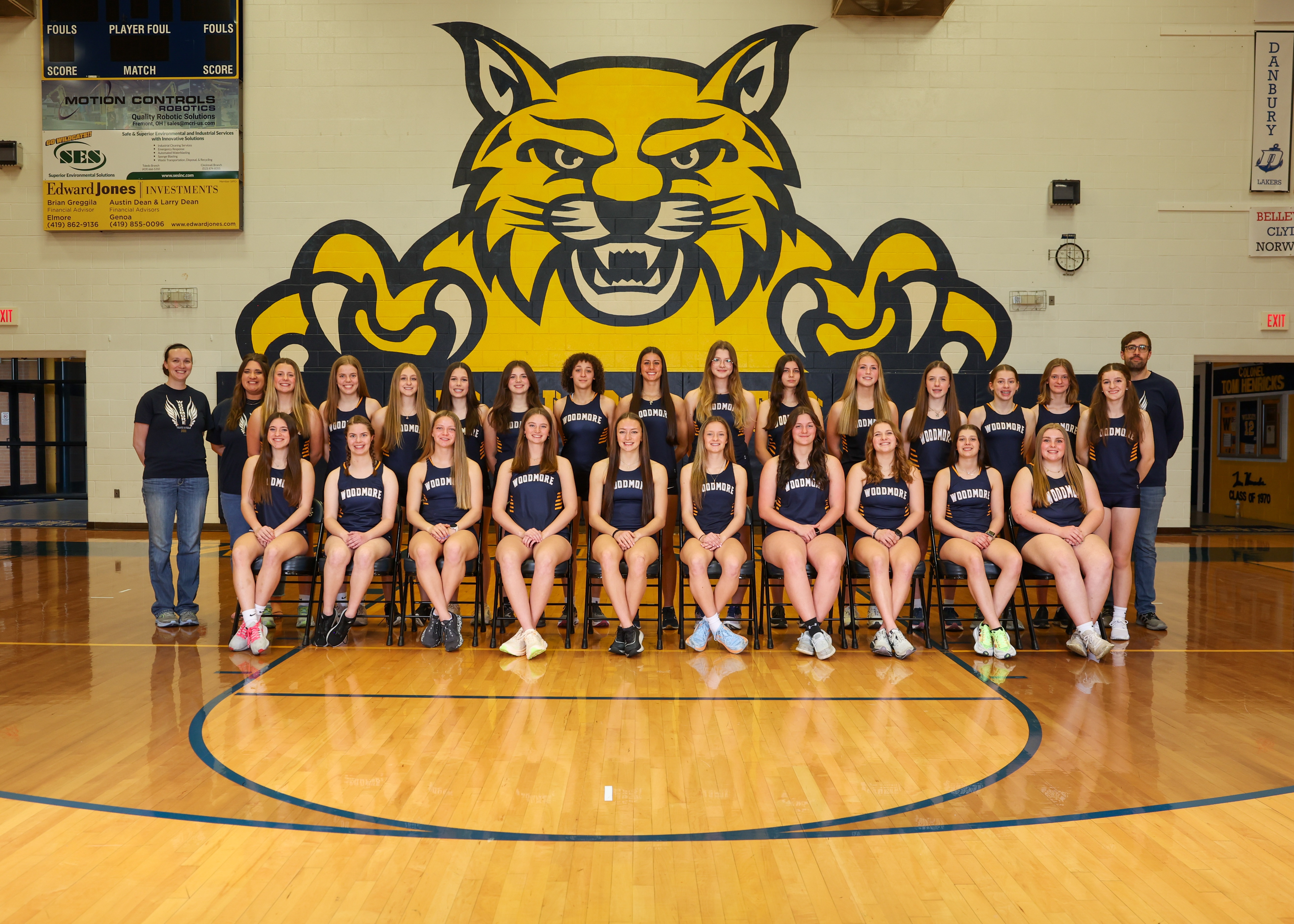 High school girls track team photo in basketball gym